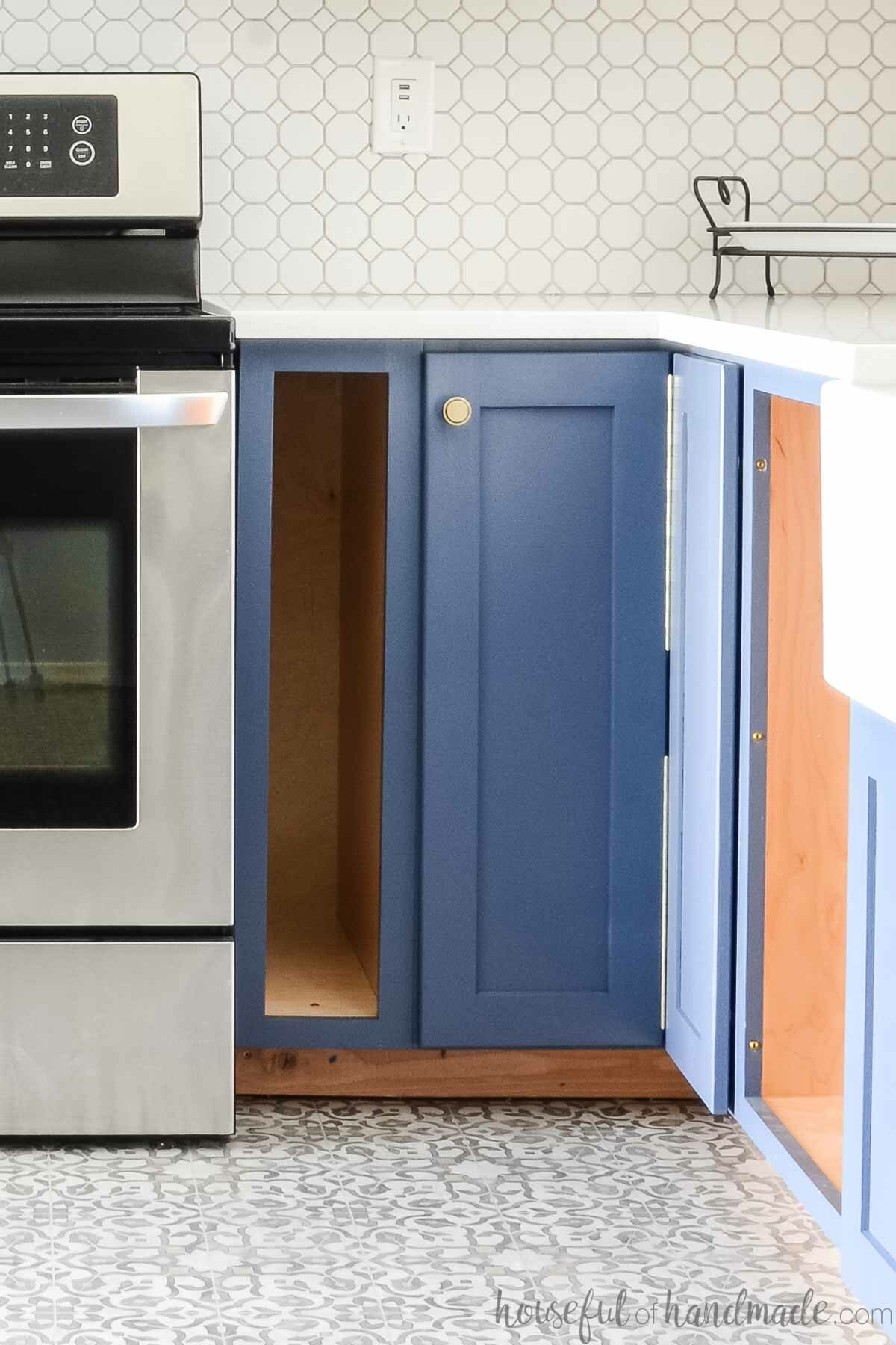 DIY bi-fold corner base cabinet in a corner next to a kitchen range.