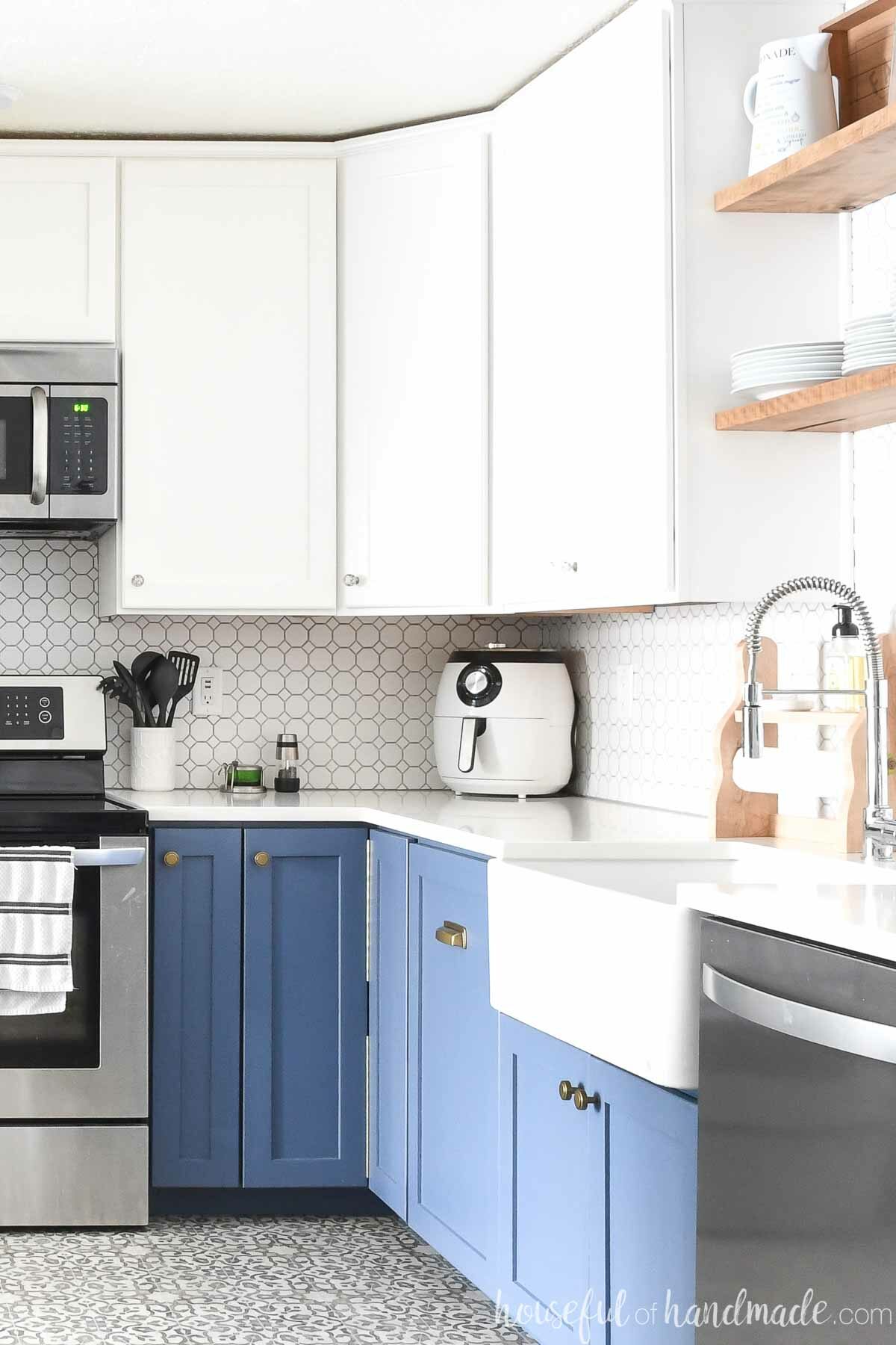 DIY corner cabinets in a kitchen with blue base cabinets and white wall cabinets. 