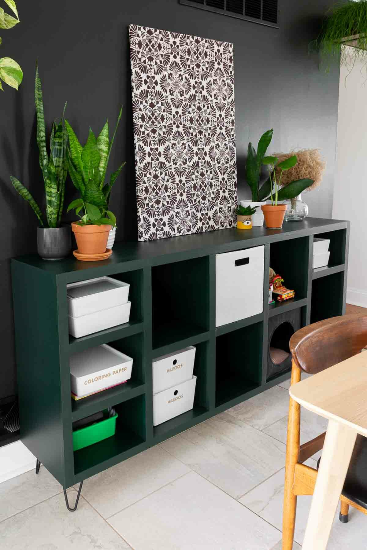 Cube storage bins in DIY console table painted with modern moody paint.