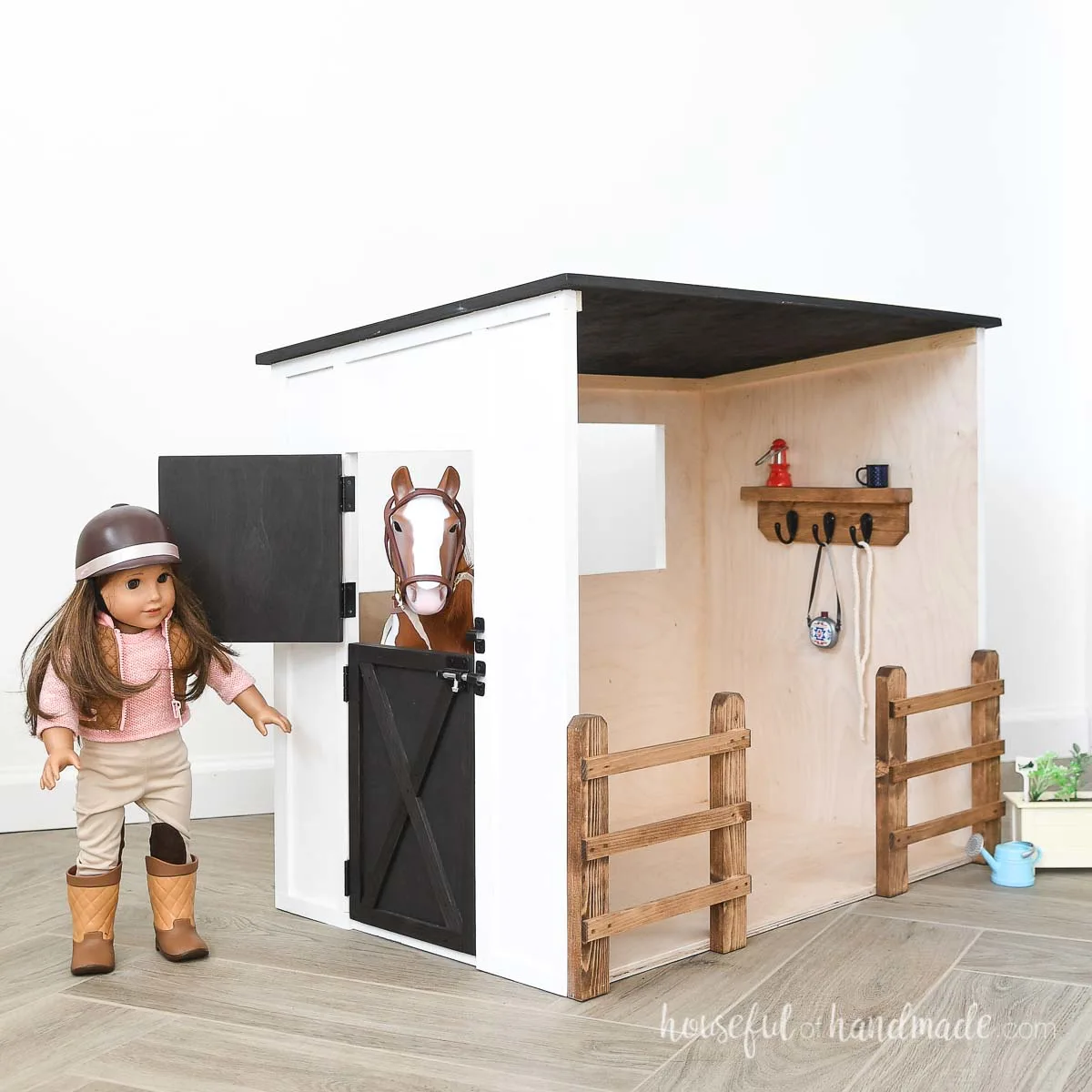 DIY plywood dollhouse of a horse stable with 20" toy horse and American girl doll playing in it. 