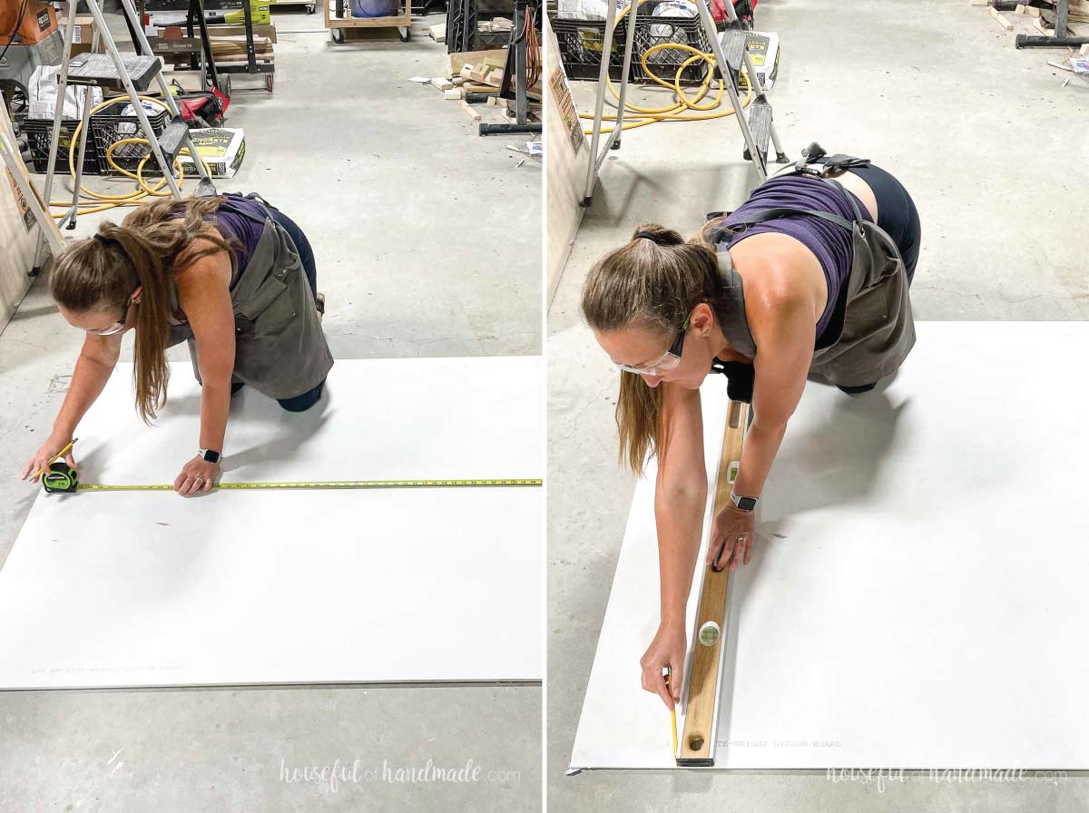 Kati measuring and marking a sheet of drywall for cutting.