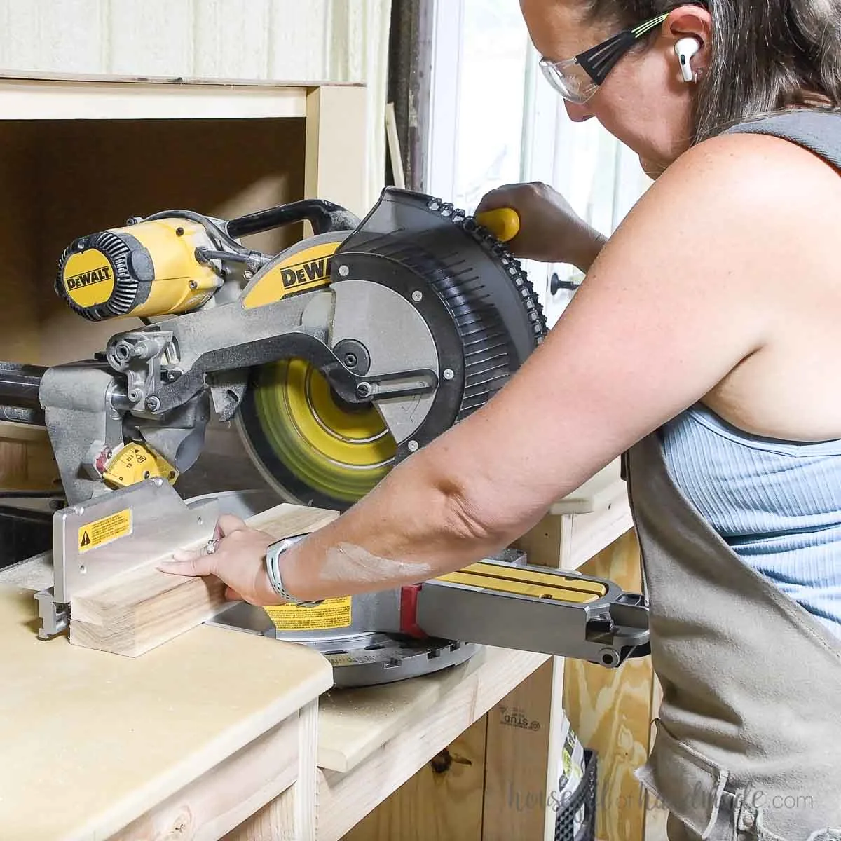 Cutting the boards for the shelf with a miter saw. 