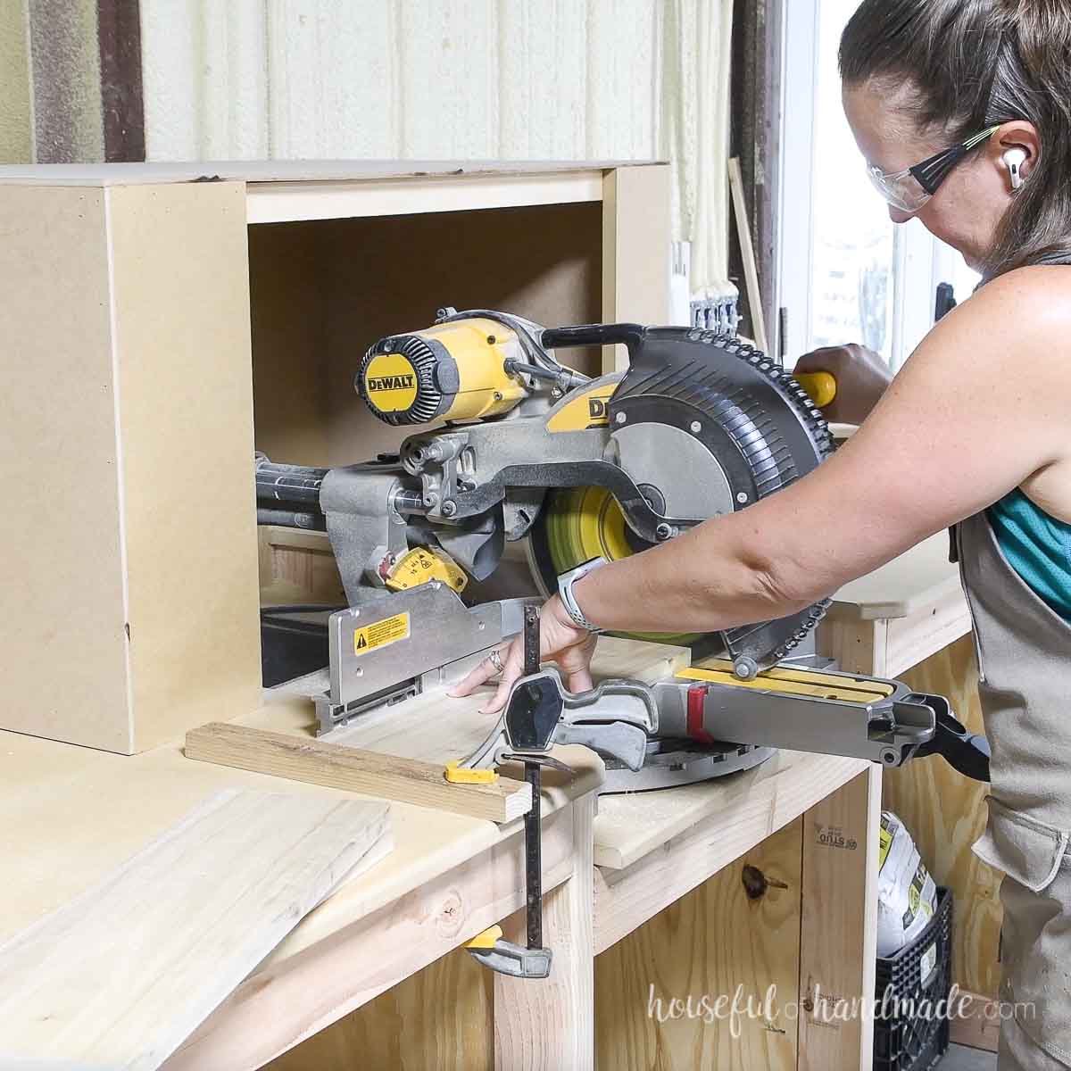 Cutting boards on a miter saw using a scrap wood as a stop.