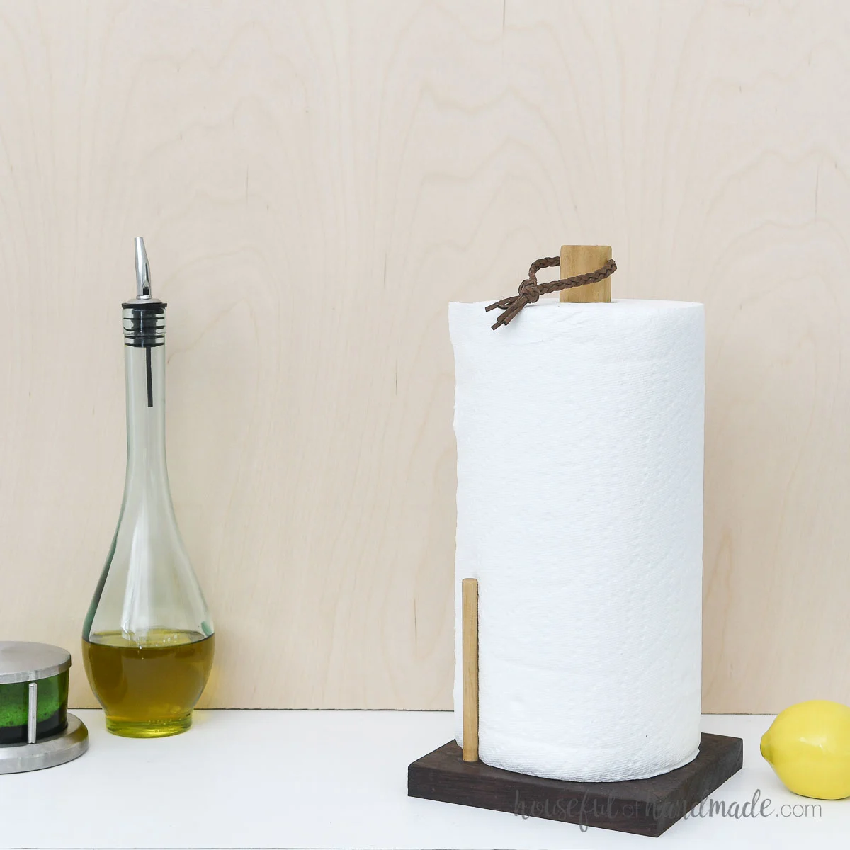 Scrap wood paper towel holder next to oil bottle and salt cellar.