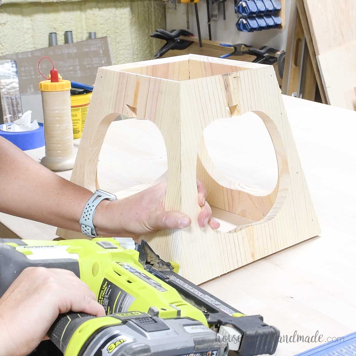 Attaching the final piece of the tapered lantern with a nailer. 