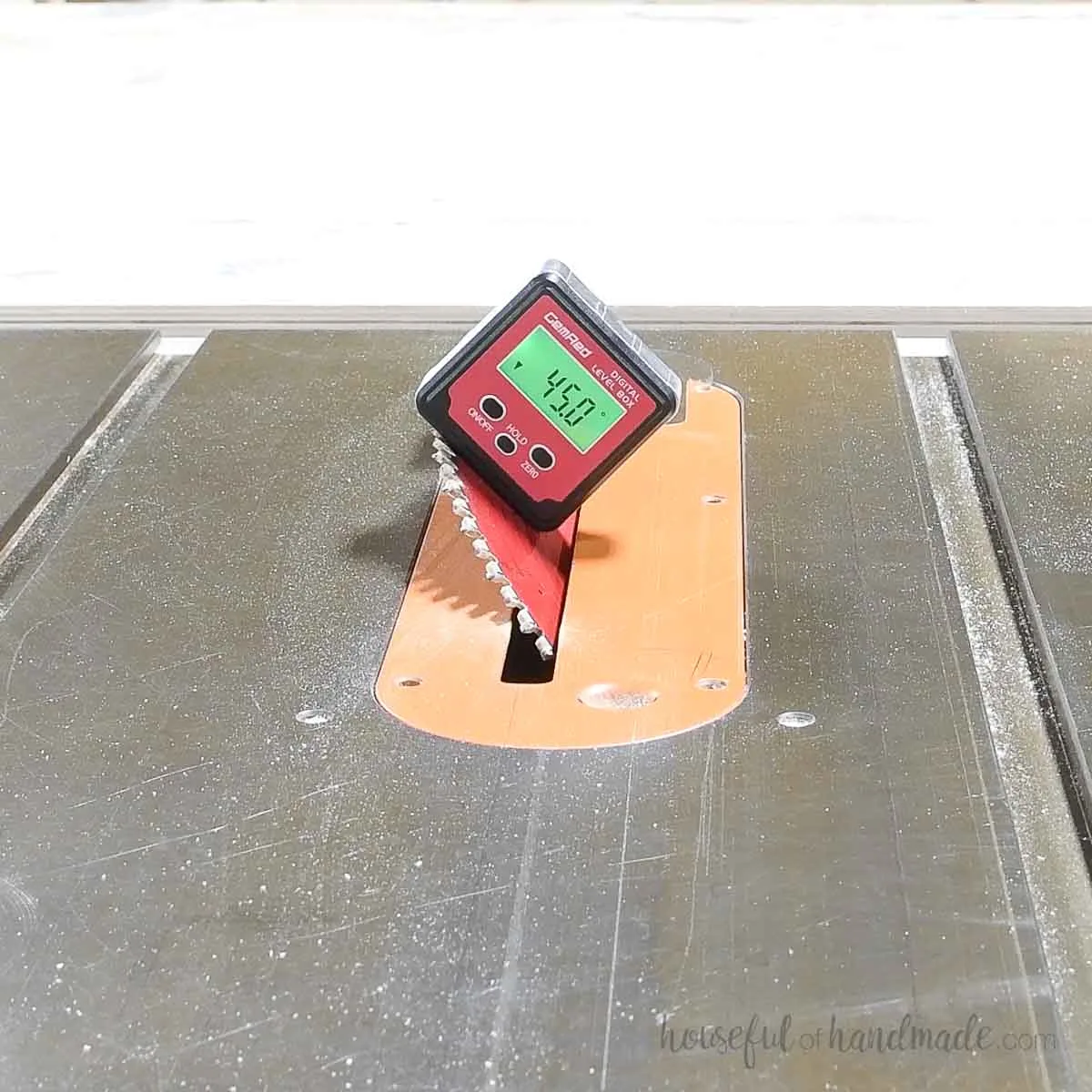 Table saw with blade set to 45 degrees with a digital angle finder. 
