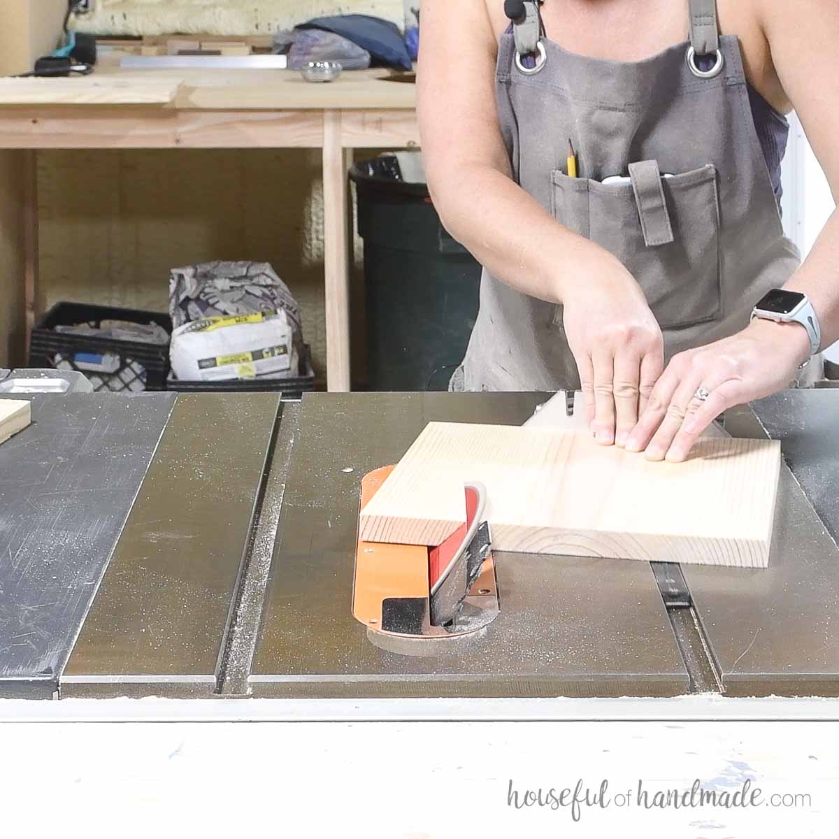 Cutting the board on the table saw at an angle with the miter gauge. 