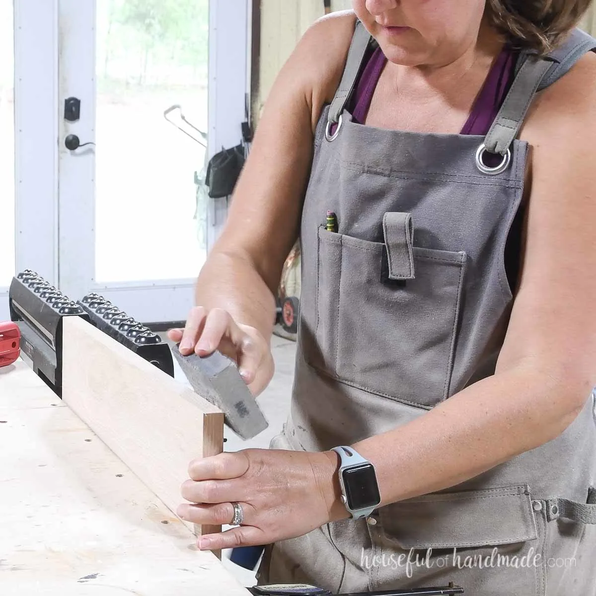 Using a sanding block to clean up the edges of the edge banding.