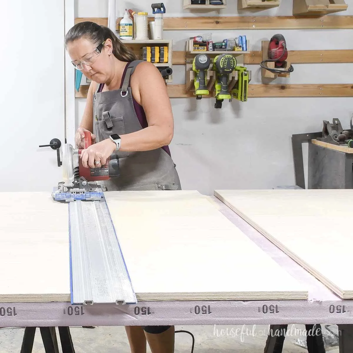 Cross-cutting the second piece of plywood for the slab cabinet doors. 