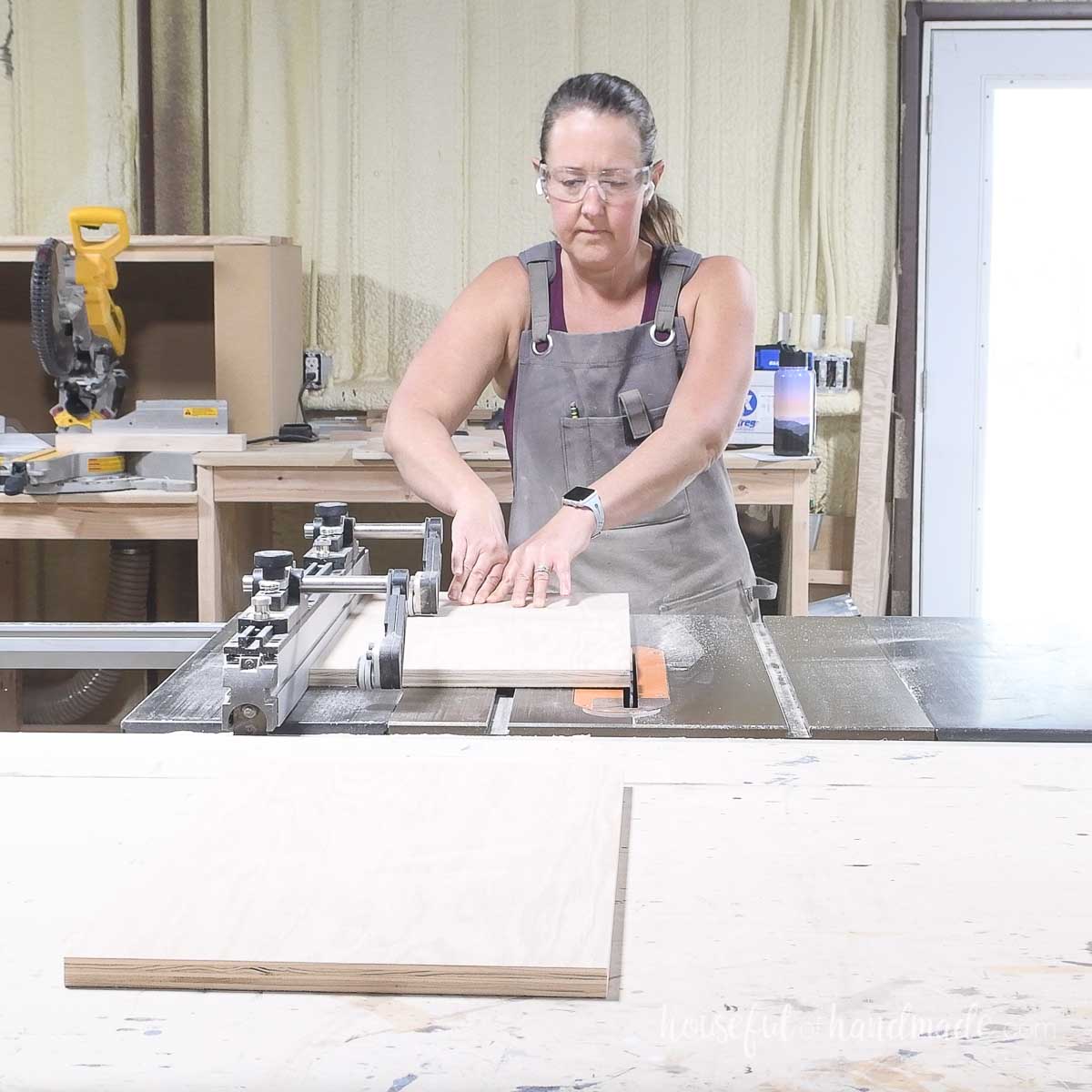 Cutting the final plywood doors to size on a table saw. 