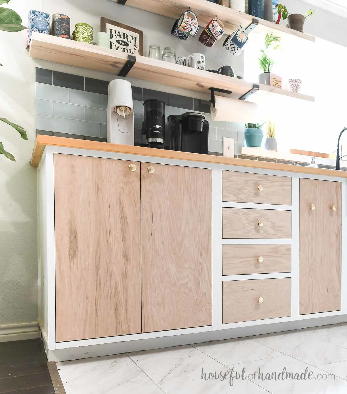 Slab kitchen cabinet doors from plywood inset into frameless white base cabinets.