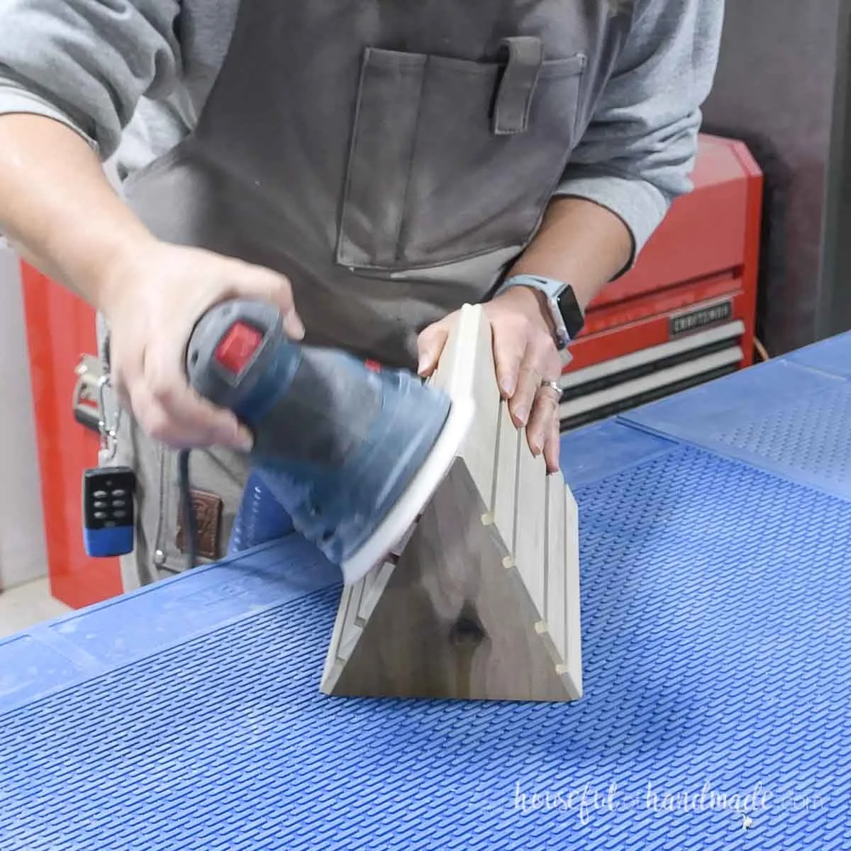 Sanding the top of book rest smooth.