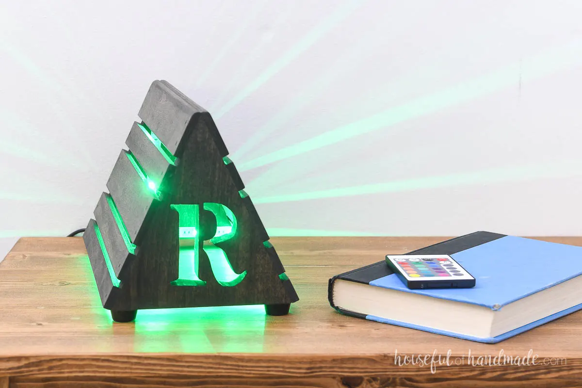 Cut out initial in the front of the wood book stand and glowing green LED lights shining though it. 