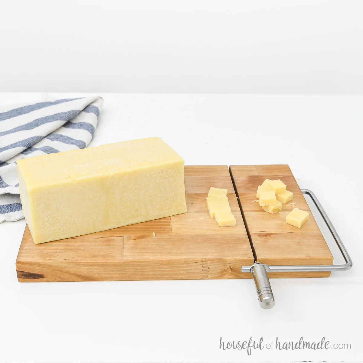 DIY cheese slicer from butcher block with a stainless steel handle.