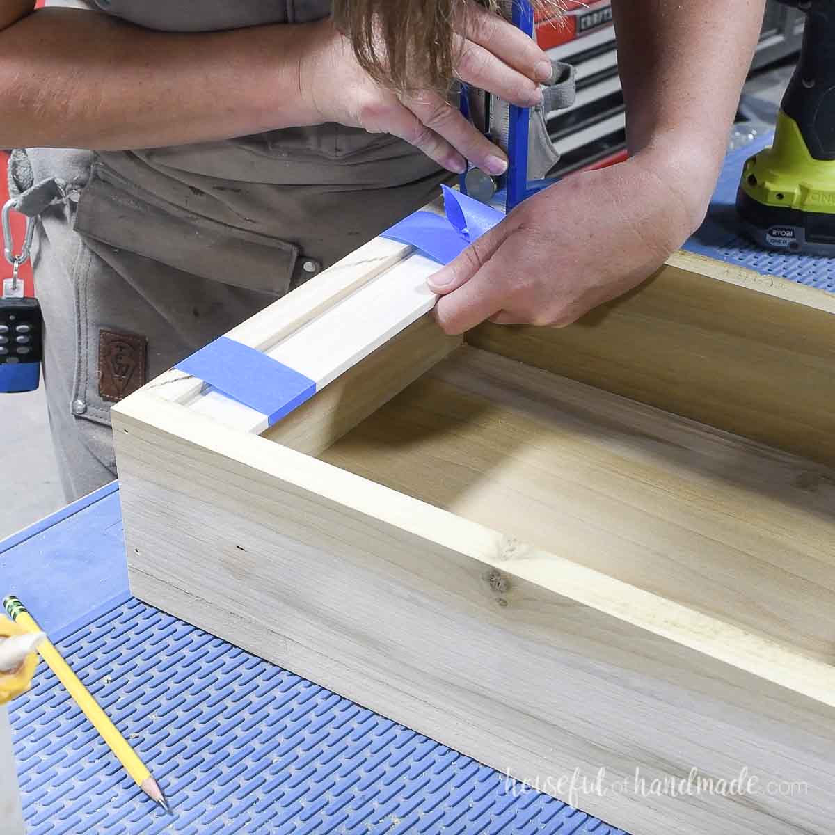 Glueing 1/4" boards into the bottom of the jewelry box and clamping with painters tape. 