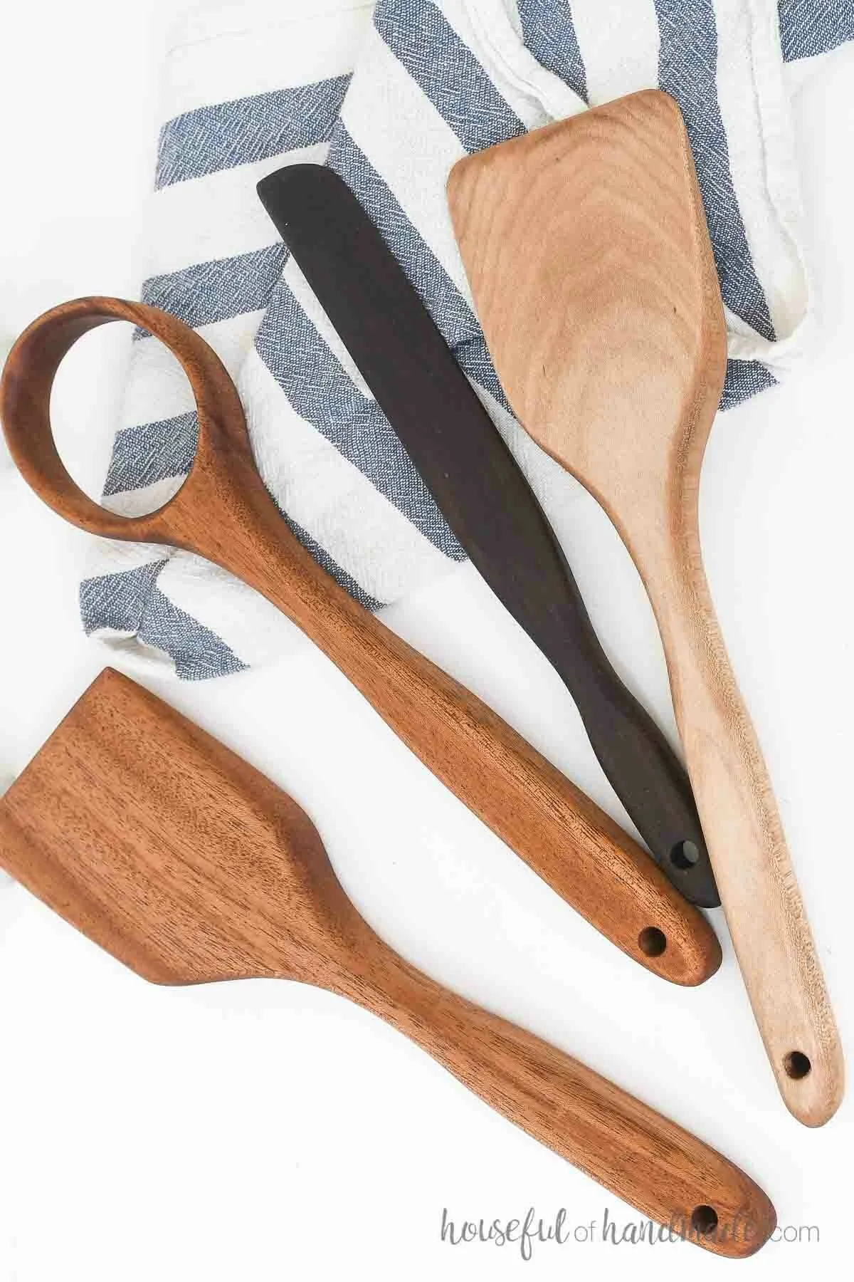 Two spatulas, a whisk, and a scraper made from scraps of hardwood.