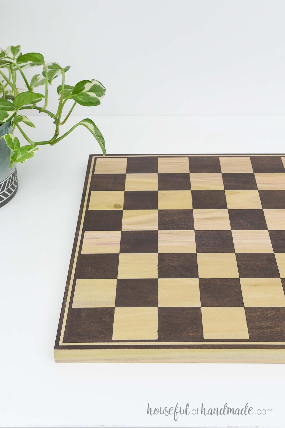 Checkerboard deign on the second side of the wood game board. 