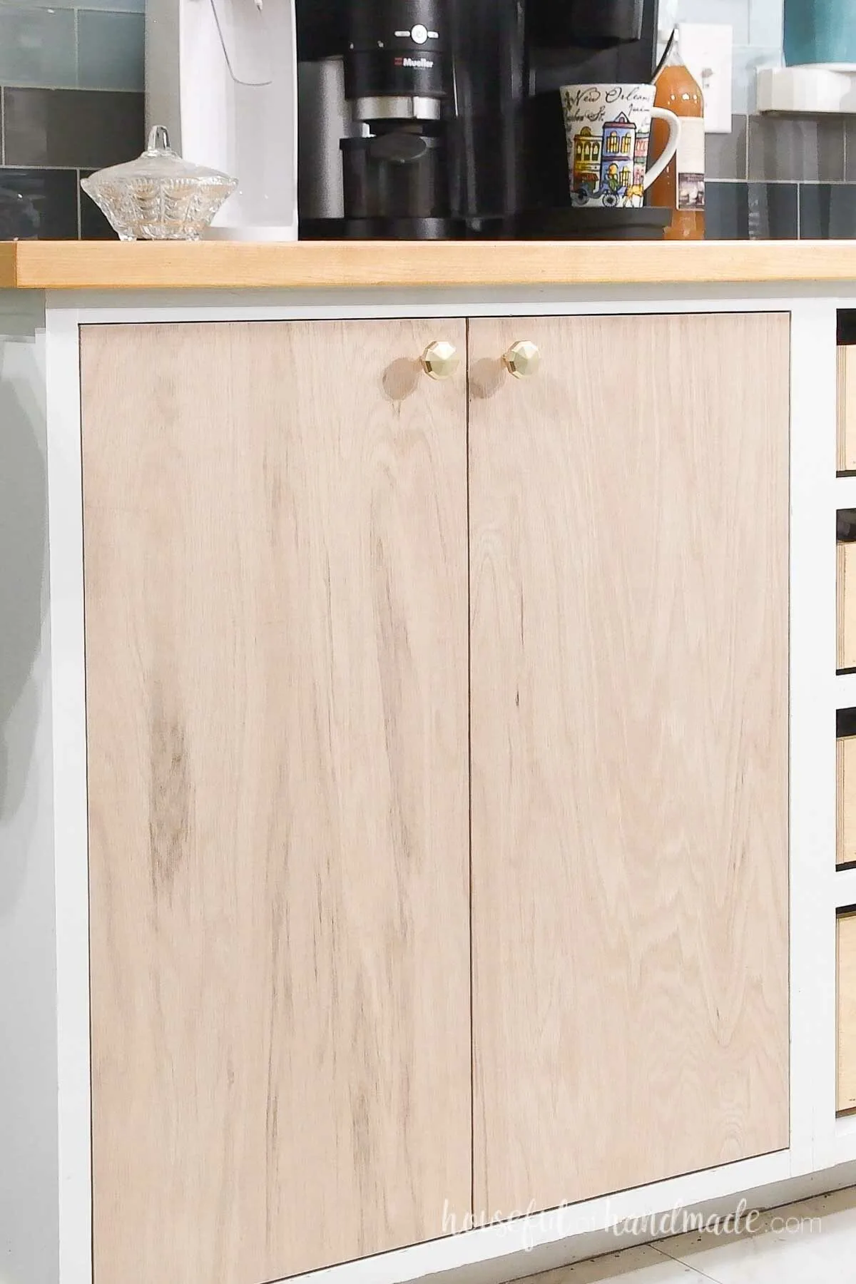 The closed cabinet doors attached with knobs.