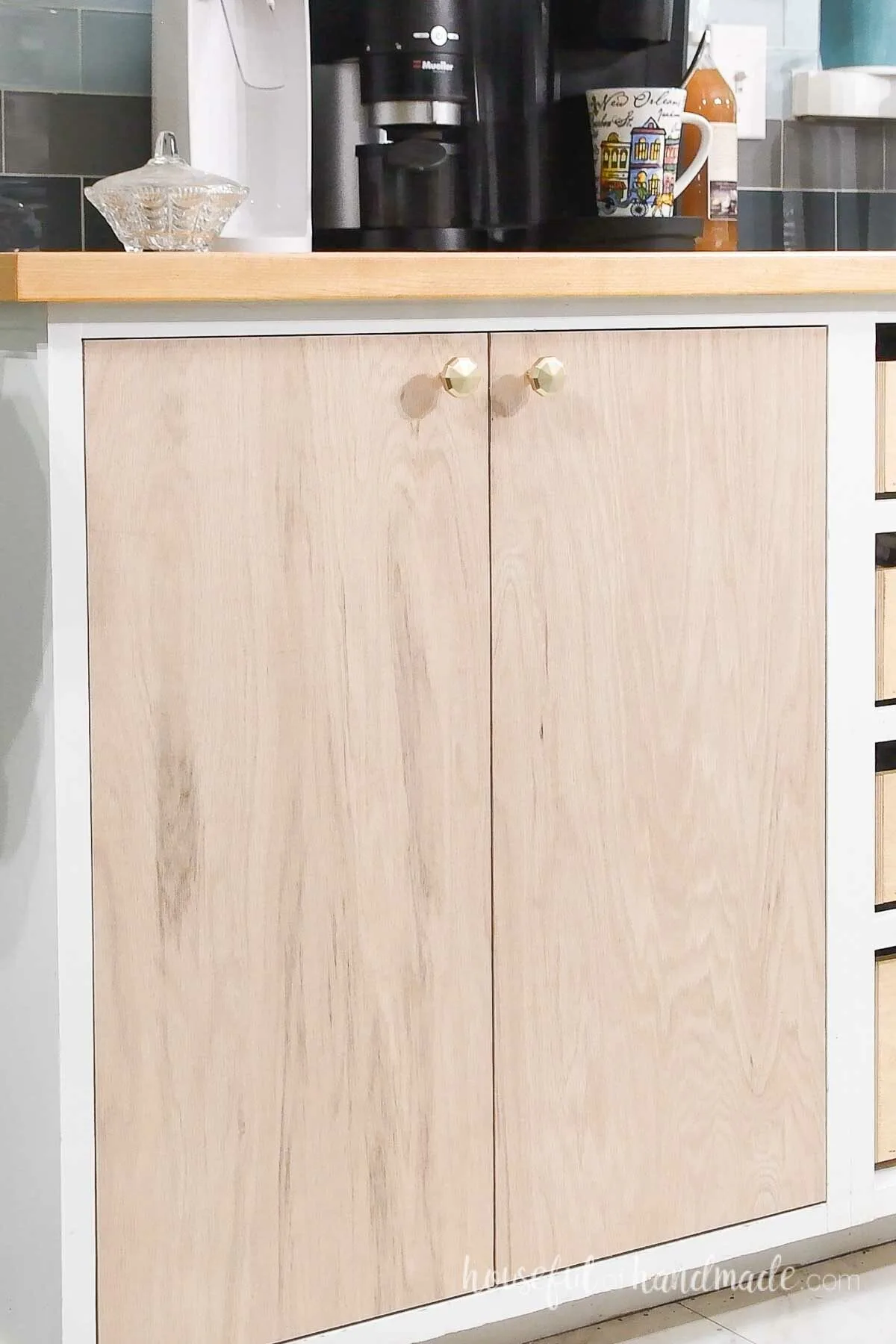 The closed cabinet doors attached with knobs. 