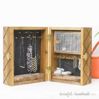DIY jewelry box with pegs for necklaces and bracelets, earring storage, and bins for small items.