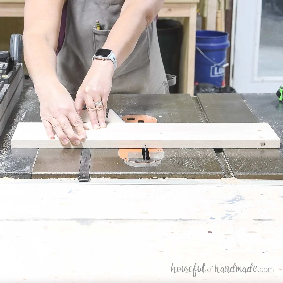 Cutting a groove in the center of the drawer front piece with a table saw. 