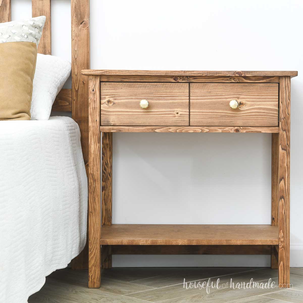 DIY nightstand with one large drawer on top and open shelf on bottom stained a medium brown.