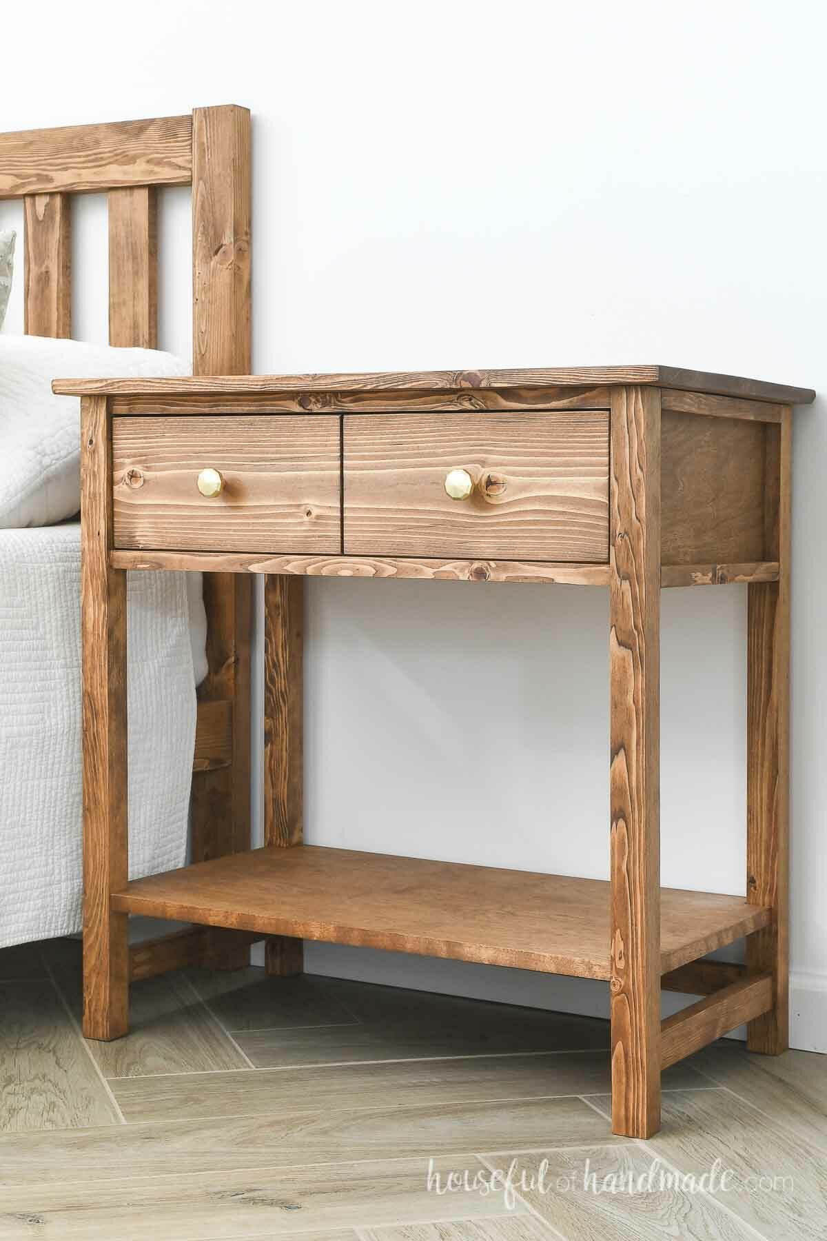 Wood nightstand with a drawer on top that looks like 2 drawers and an open shelf.