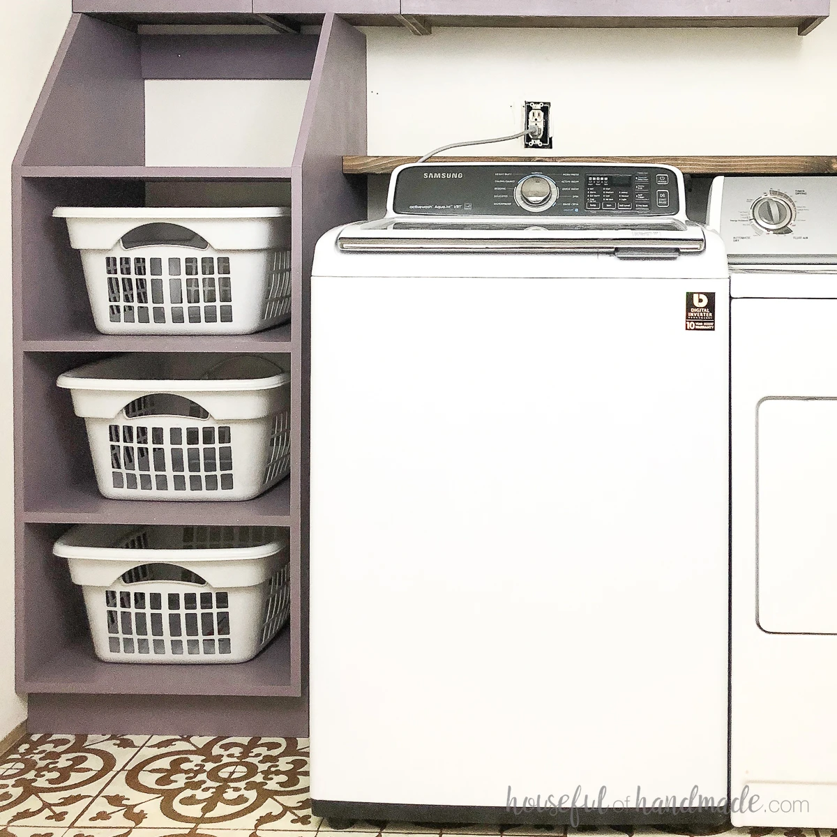 Purple painted stackable laundry basket storage next to a washing machine. 