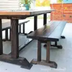 DIY dining table bench next to large dining table.