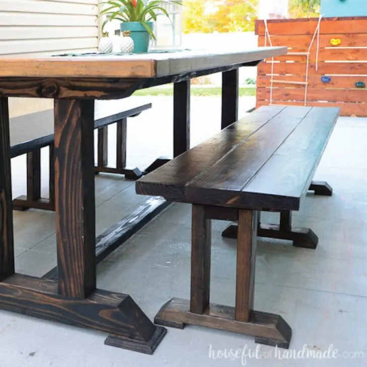DIY dining table bench next to large dining table.