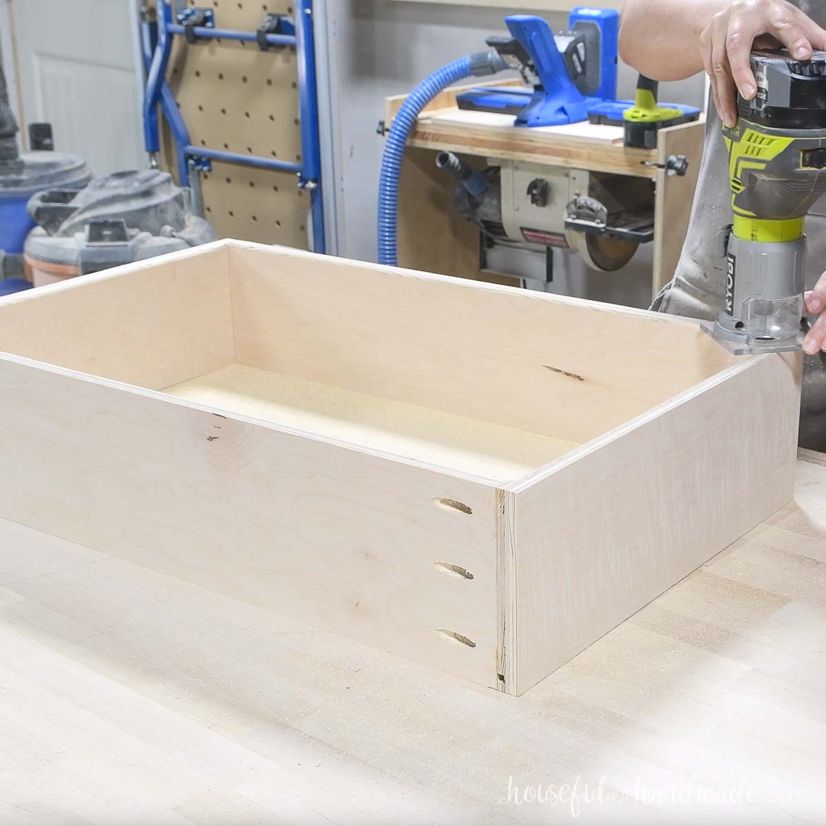 Rounding over the inside edge of the drawer box with a trim router. 