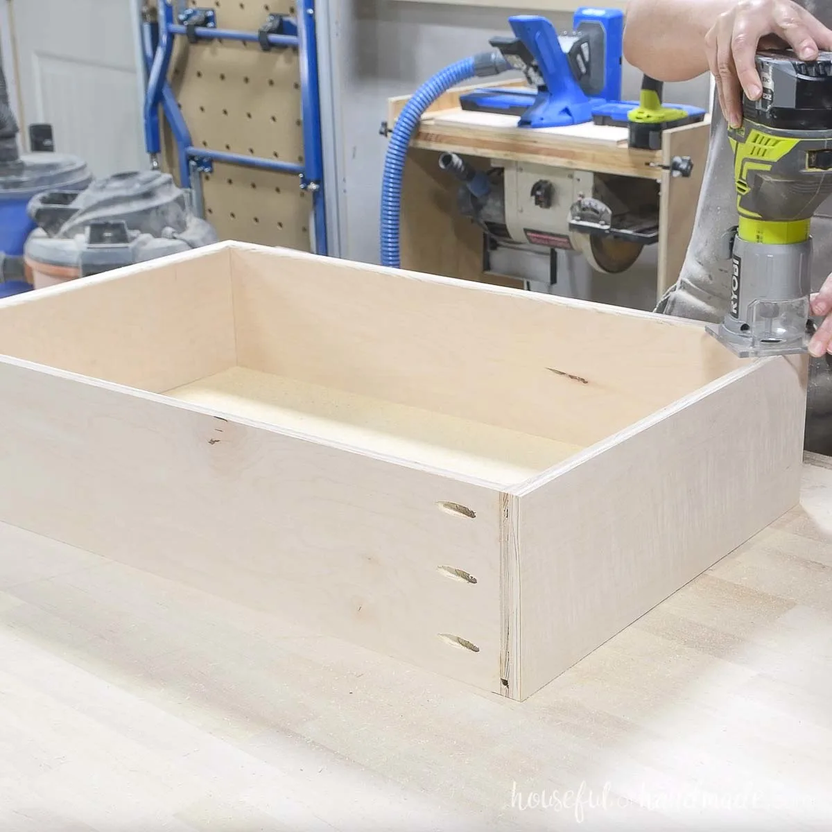 Rounding over the inside edge of the drawer box with a trim router. 