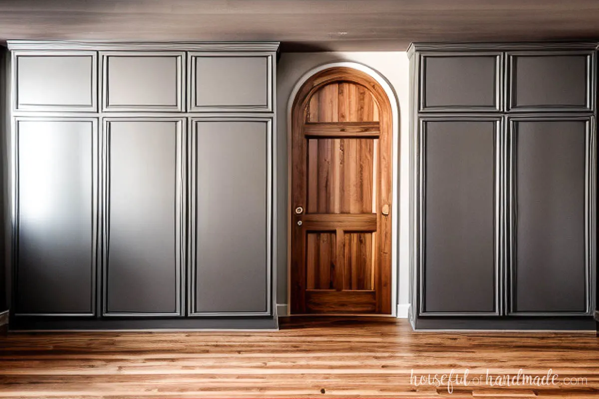 Wall of pantry cabinets around an arched doorway. 