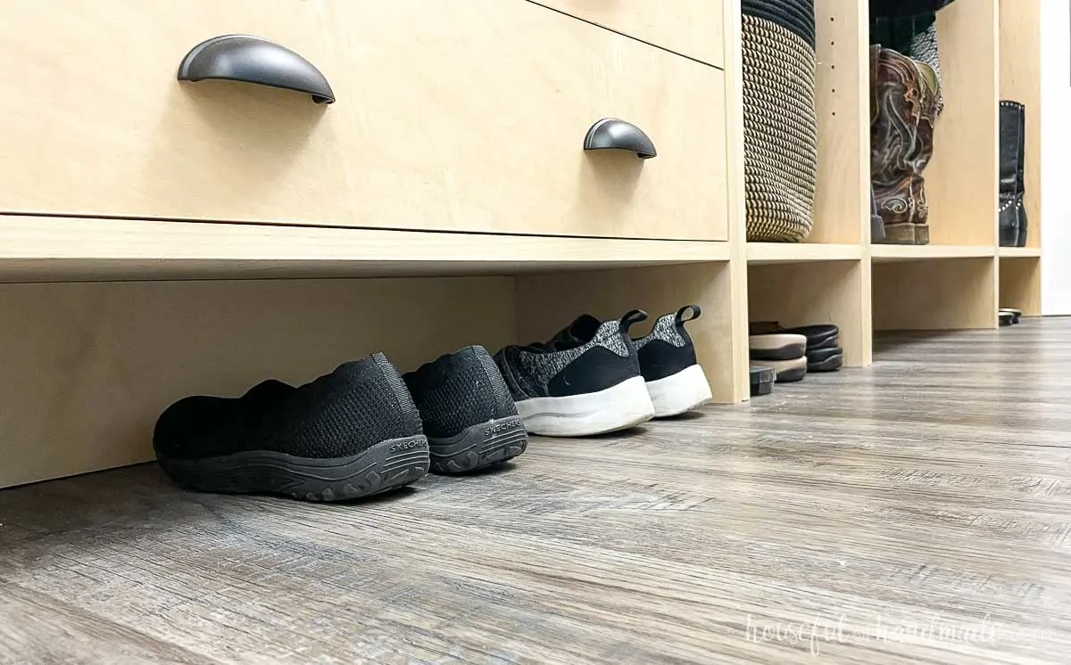 Shoe storage in the toe kick of the closet cabinets. 