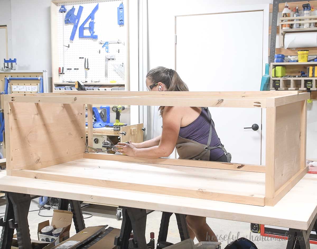 Attaching the back pieces to complete the dresser frame.