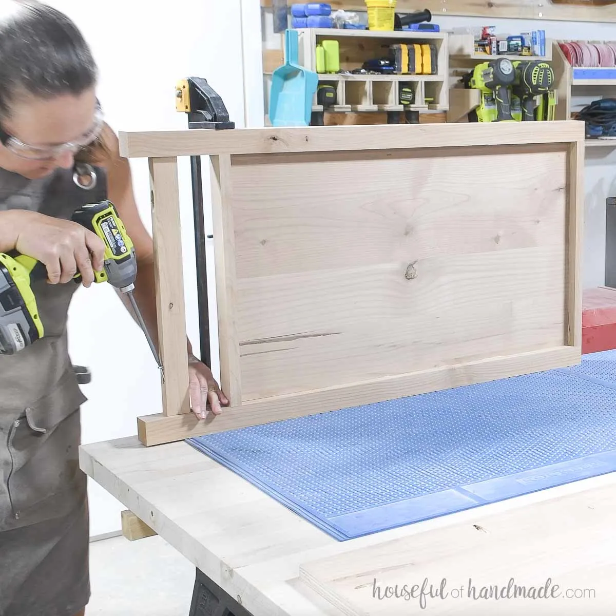 Attaching the second leg to the side of the dresser. 