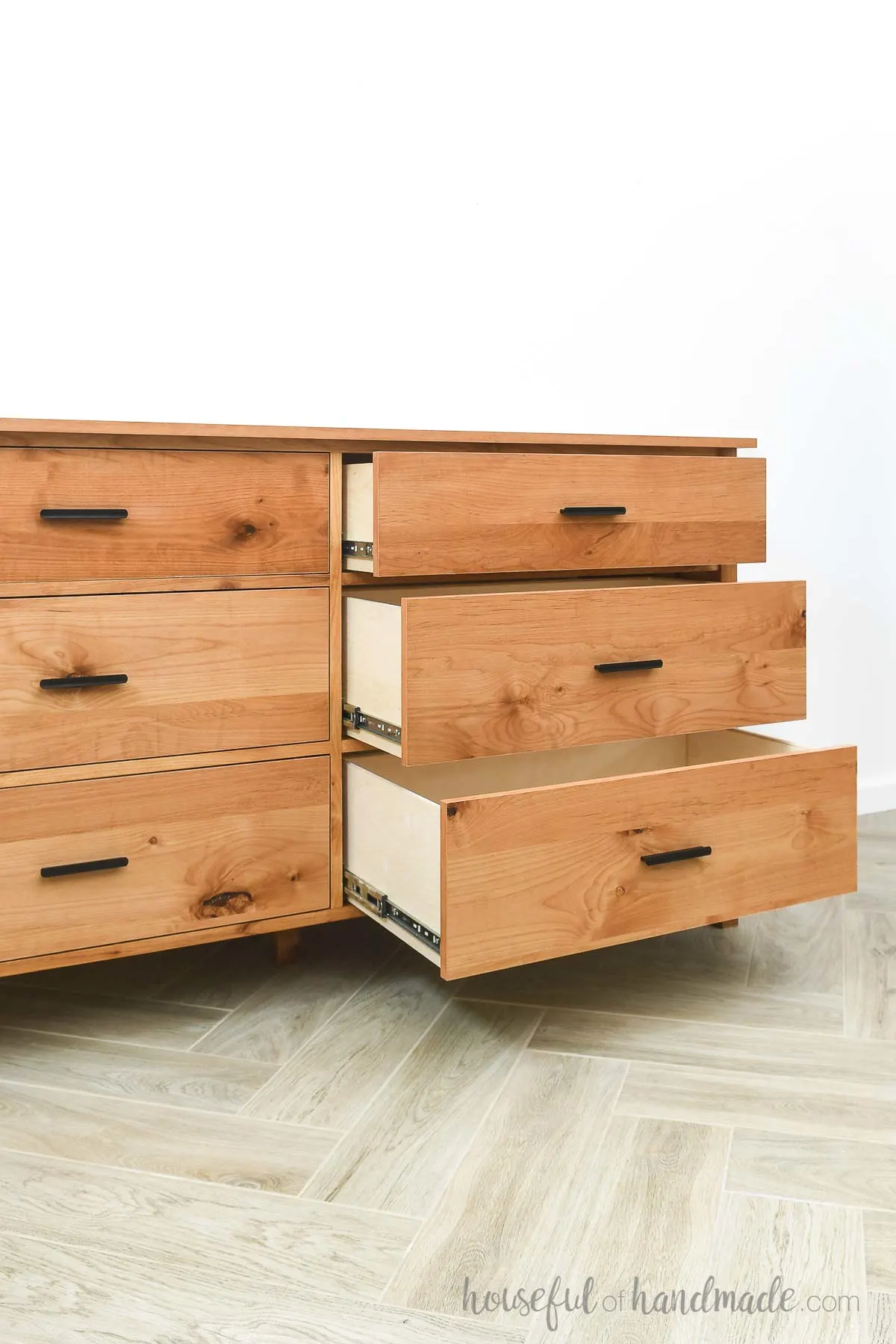 Six drawer dresser with three drawers on one side all opened showing the large drawer boxes. 
