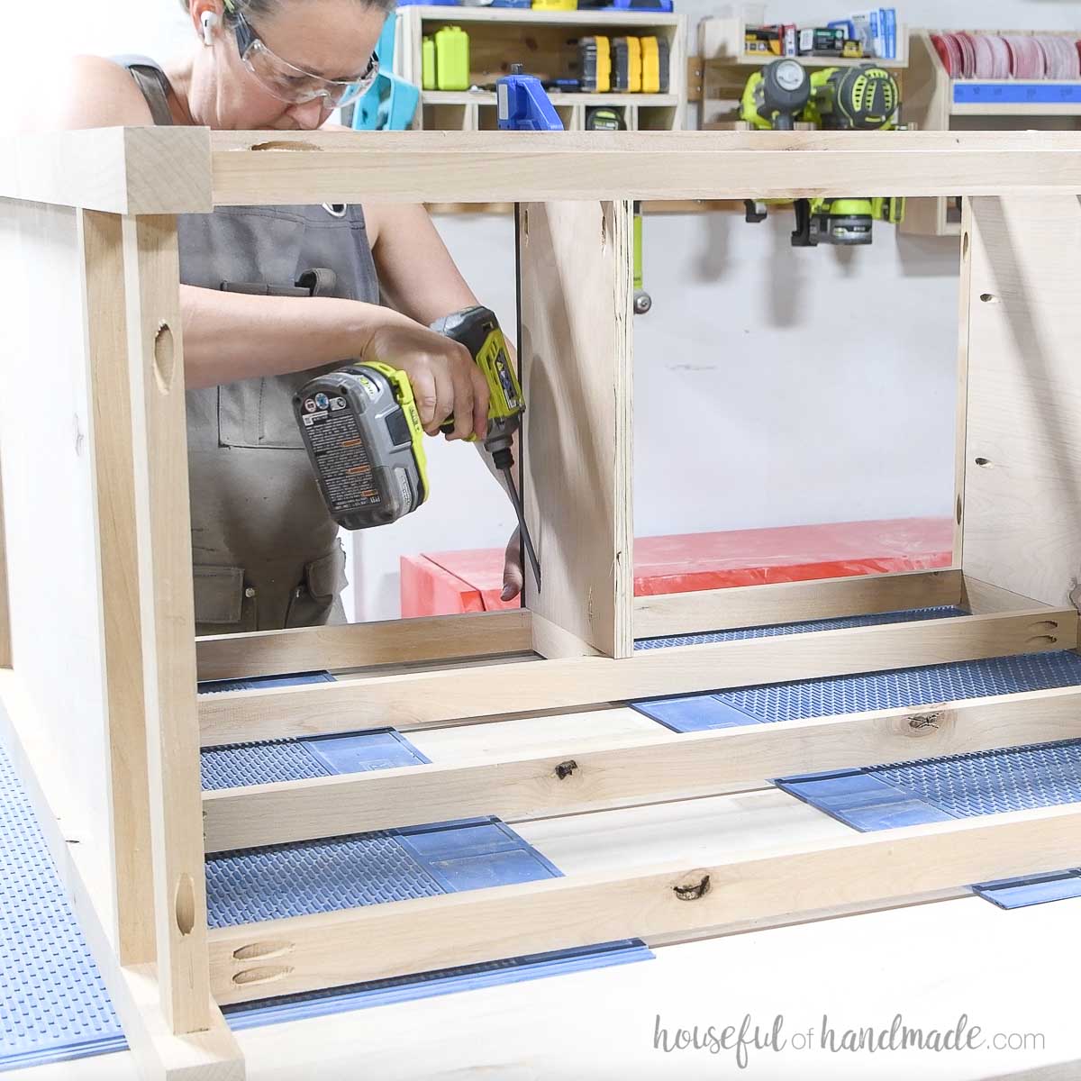 Attaching a plywood panel to the center top of the dresser frame. 