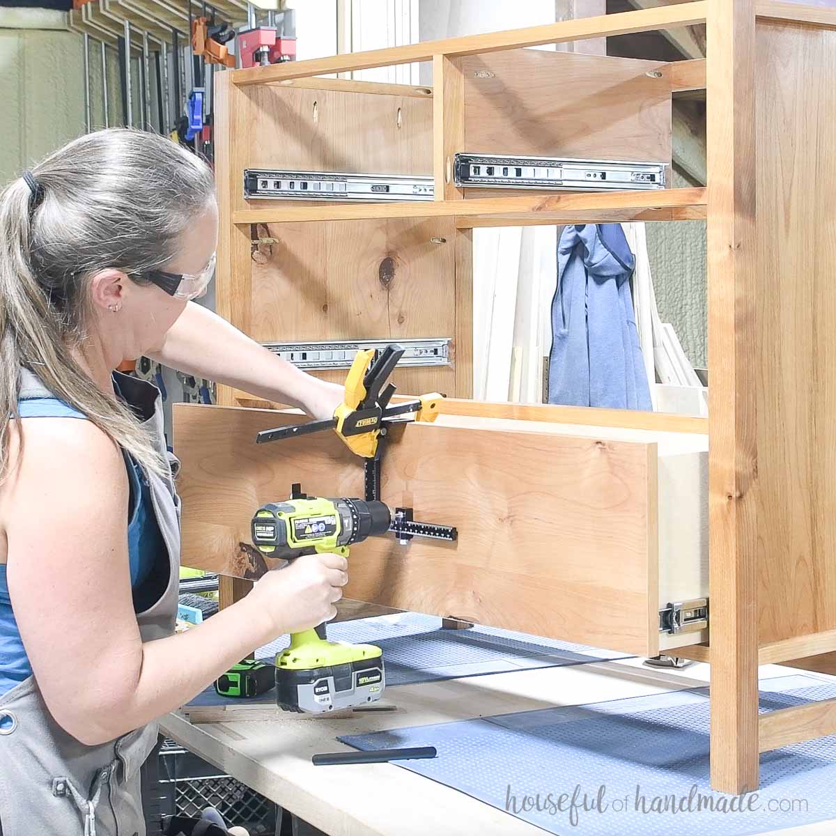 Drilling holes for the drawer slides with a jig. 
