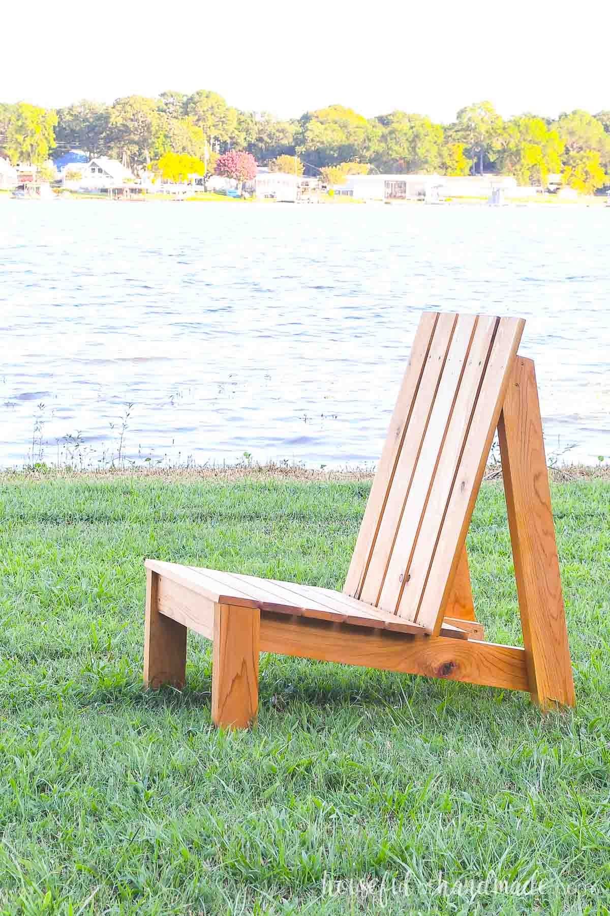 Side view of a cedar adirondack chair with modern lines and no arm rests. 