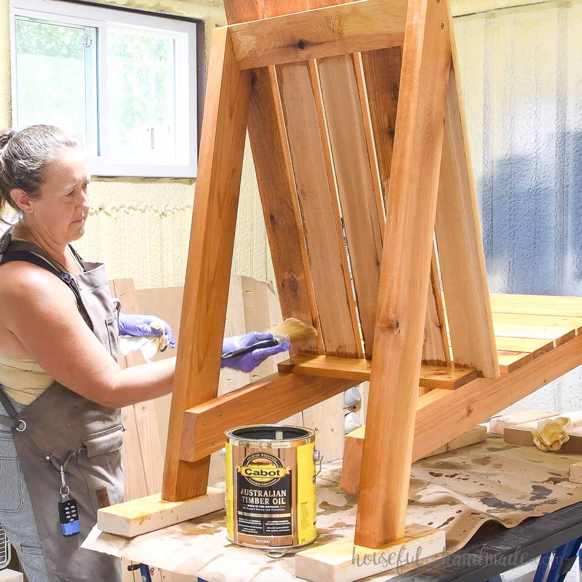 Sealing the cedar Adirondack chair with Cabot Australian Timber Oi. 