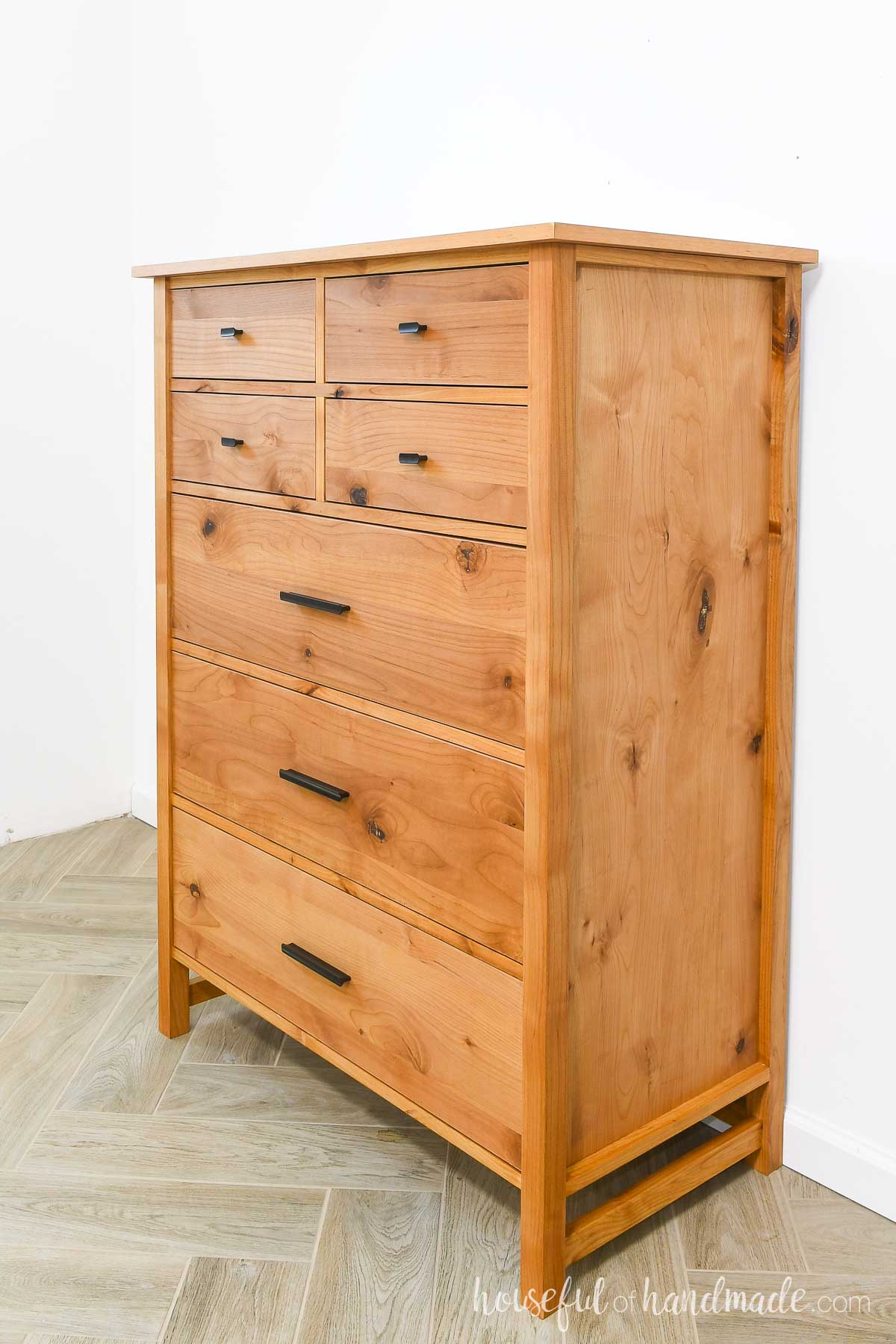 Side view of tall dresser with 2 sizes of drawers. 