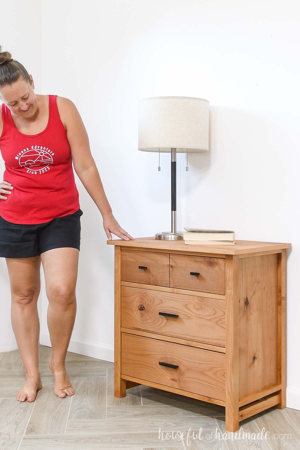 Kati standing next to the 3 drawer nightstand she built. 