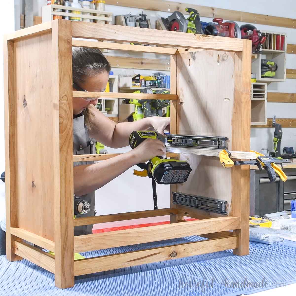 Attaching drawer slides to the side of the nightstand frame. 