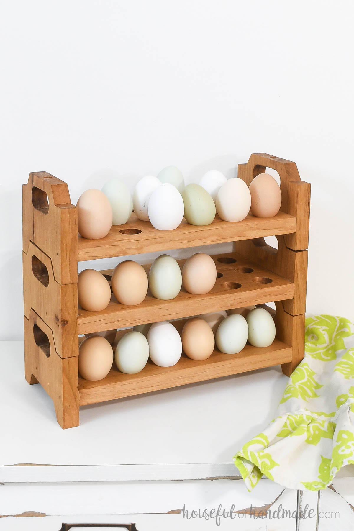 Stacking wood egg holder with handles on the sides holding 18 eggs per tray. 