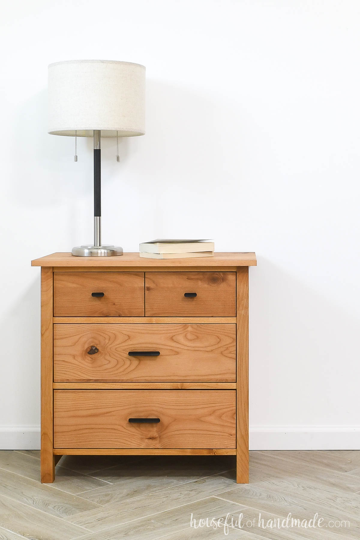 Front view of nightstand with 3 inset drawers.