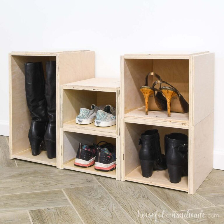 Three different sized stackable shoe storage boxes with women's shoes in them.