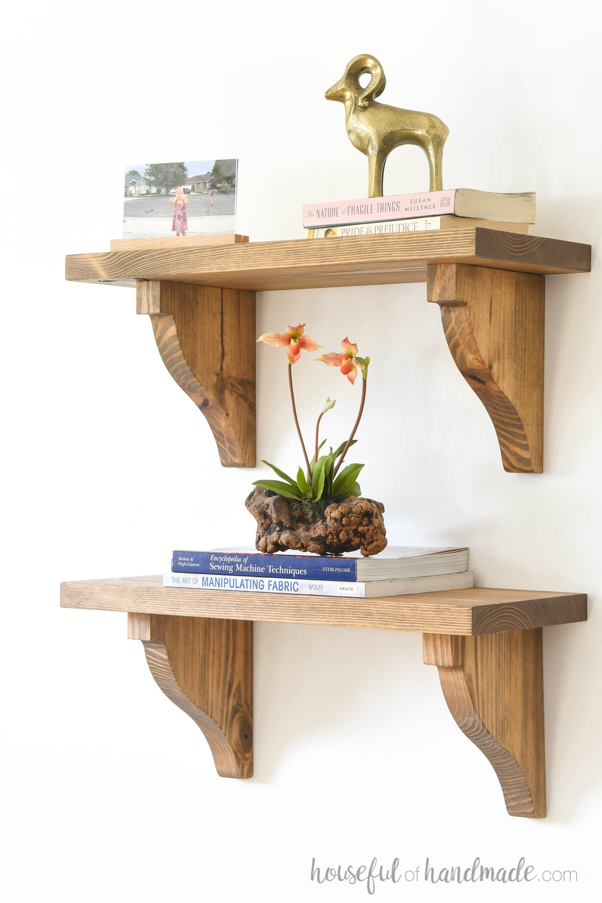 Two shelves held up with wood corbels as shelf brackets. 