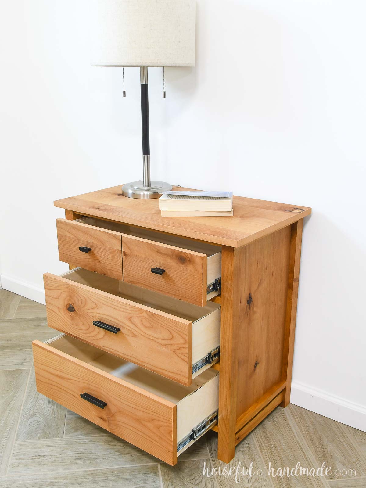 Nightstand with 3 drawers slightly open to show the plywood drawer boxes. 