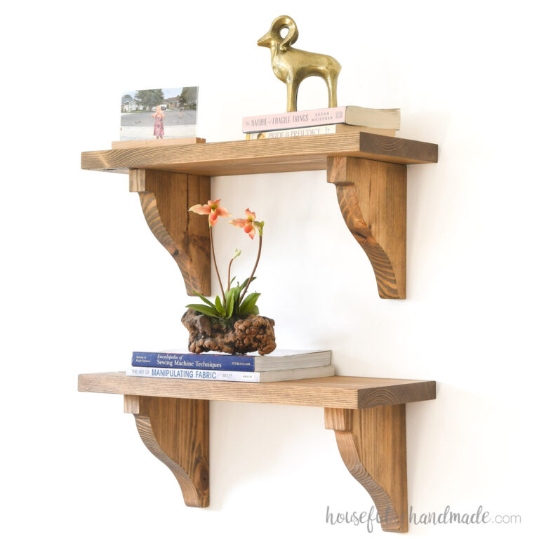 DIY wood shelf bracket corbels with books, flowers and pictures on the shelves.